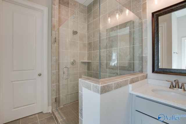 full bath featuring a stall shower, tile patterned flooring, and vanity