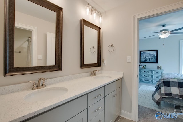 full bath with a ceiling fan, a sink, and double vanity