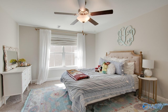 bedroom with light carpet, baseboards, and a ceiling fan