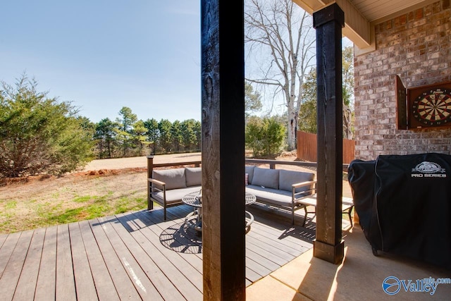 wooden terrace featuring outdoor lounge area and grilling area