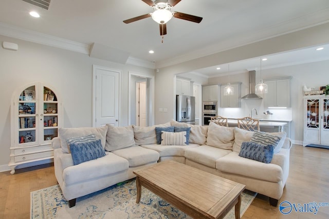 living room featuring ceiling fan, recessed lighting, visible vents, and light wood-style floors