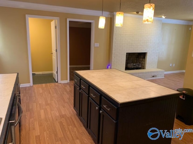 kitchen with a kitchen island, pendant lighting, and light countertops