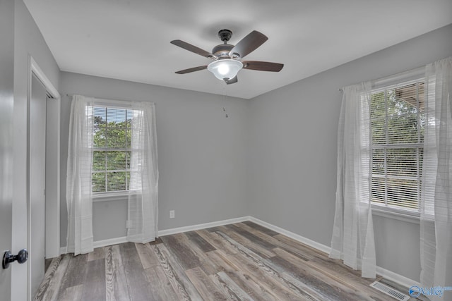 empty room featuring ceiling fan and light hardwood / wood-style floors