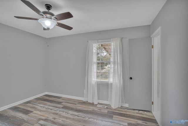 empty room with light hardwood / wood-style flooring and ceiling fan