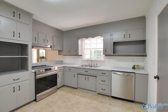 kitchen featuring gray cabinets, sink, light tile patterned flooring, and stainless steel appliances