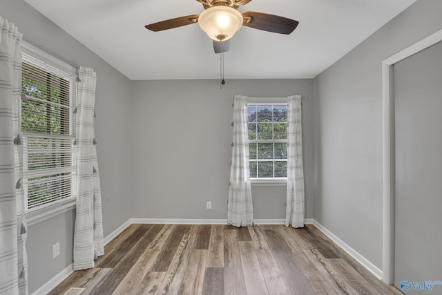 unfurnished room with wood-type flooring and ceiling fan