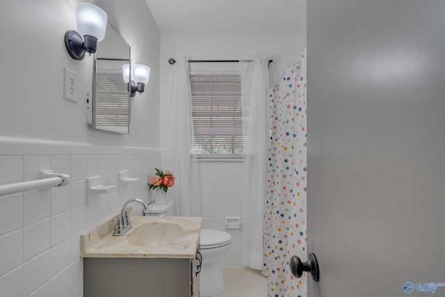 bathroom featuring vanity, tile walls, curtained shower, and toilet