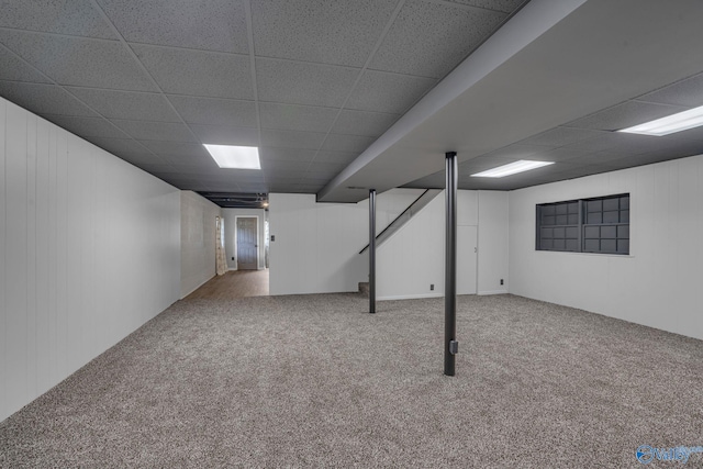 basement featuring carpet floors and a drop ceiling