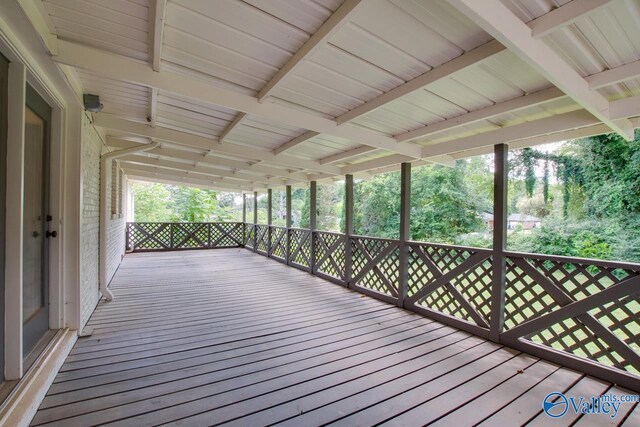 basement featuring a paneled ceiling, a wood stove, and carpet floors