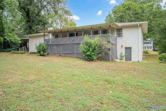 back of house with a lawn