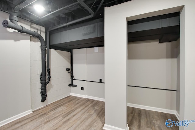 basement with hardwood / wood-style floors