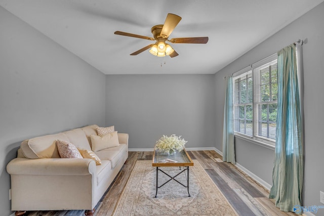 living room featuring hardwood / wood-style flooring and ceiling fan