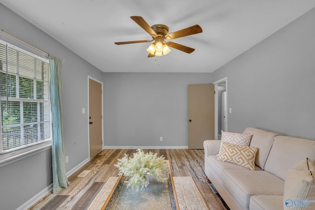 living room with ceiling fan and light hardwood / wood-style floors