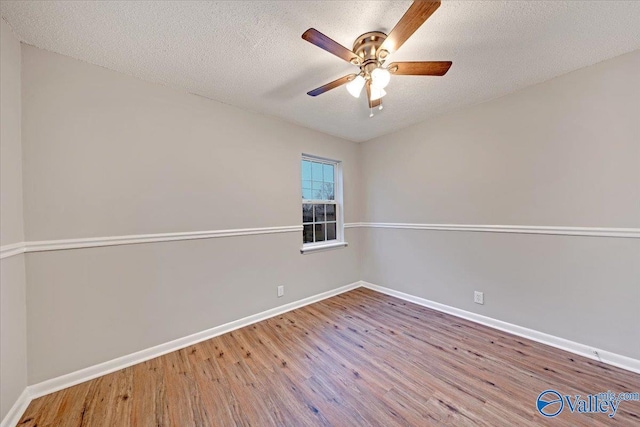 spare room with a textured ceiling, ceiling fan, and hardwood / wood-style flooring