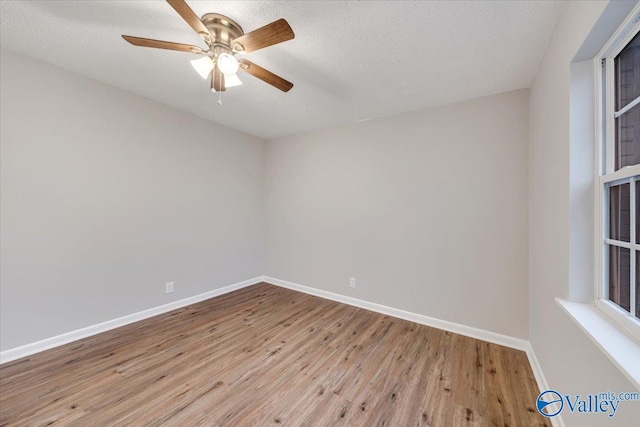 unfurnished room featuring a textured ceiling, ceiling fan, and light hardwood / wood-style floors