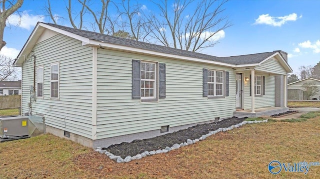 view of front of house with a front yard and central air condition unit