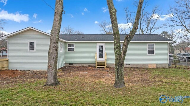 rear view of property with a lawn