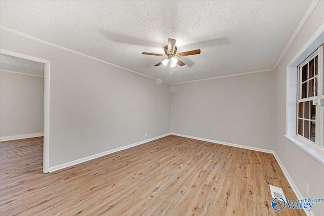 spare room with a textured ceiling, ceiling fan, crown molding, and light hardwood / wood-style flooring