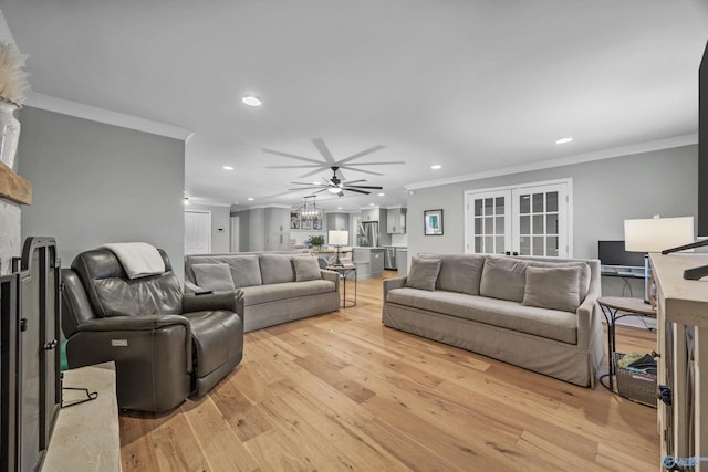 living room featuring light hardwood / wood-style floors, crown molding, and ceiling fan