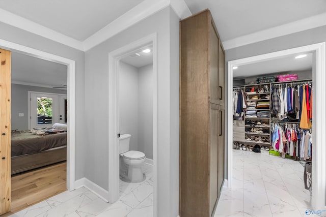 bathroom with ornamental molding, french doors, hardwood / wood-style flooring, and toilet