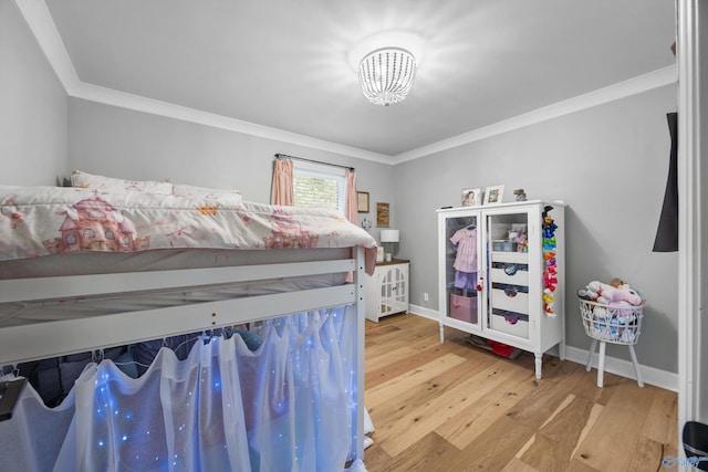 bedroom with crown molding and wood-type flooring