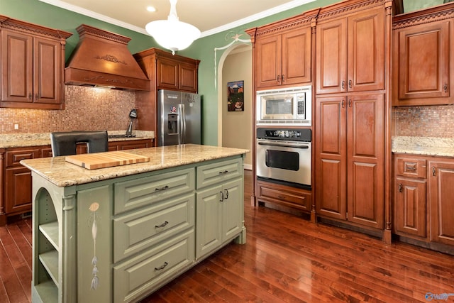 kitchen featuring custom range hood, tasteful backsplash, dark wood-type flooring, a kitchen island, and stainless steel appliances