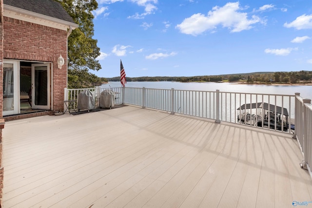 wooden deck featuring a water view