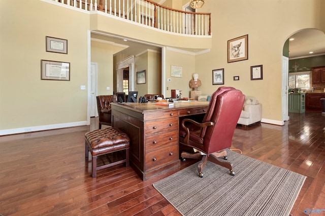 home office featuring dark hardwood / wood-style floors and a towering ceiling