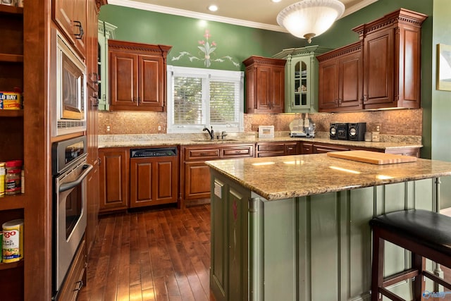 kitchen with backsplash, crown molding, light stone countertops, a kitchen breakfast bar, and dark hardwood / wood-style flooring