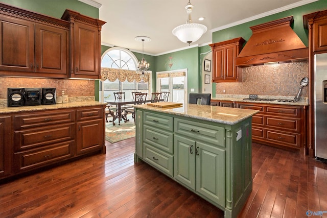 kitchen with a kitchen island, dark wood-type flooring, pendant lighting, and custom range hood