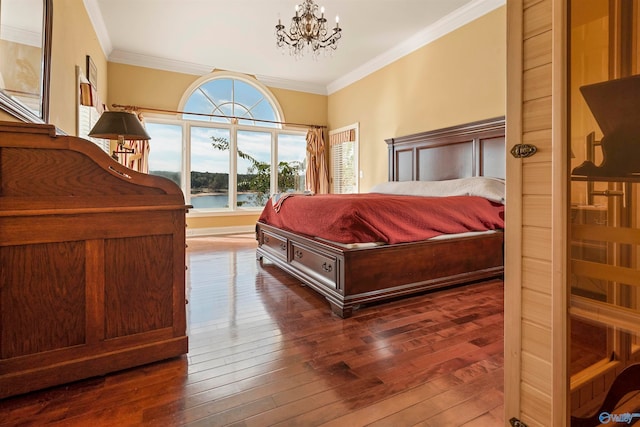 bedroom featuring dark hardwood / wood-style flooring, an inviting chandelier, and crown molding