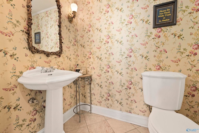 bathroom with ornamental molding, tile patterned flooring, and toilet