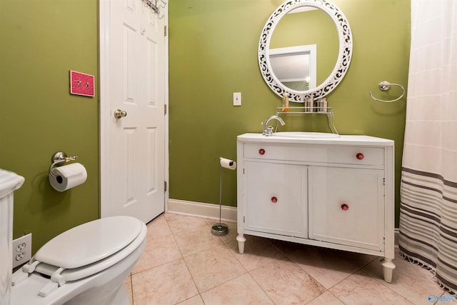 bathroom featuring tile patterned floors, toilet, and vanity