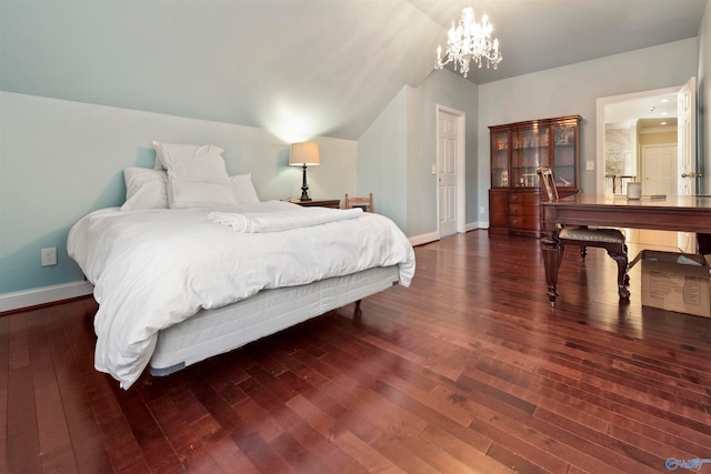 bedroom featuring an inviting chandelier, hardwood / wood-style flooring, and lofted ceiling