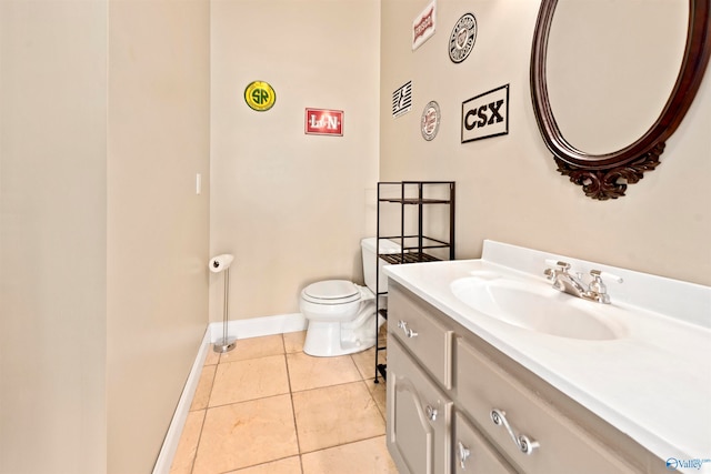 bathroom featuring vanity, tile patterned flooring, and toilet