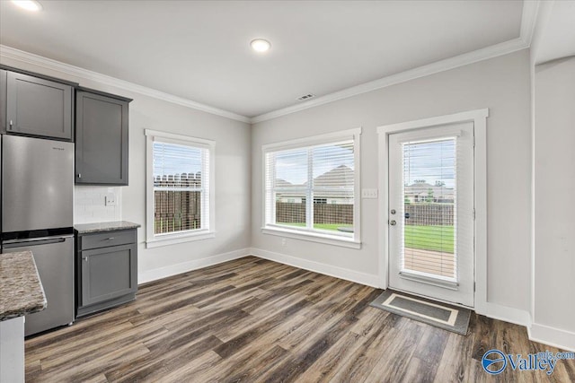246 Tybee Dr, Madison, AL 35756 - unfurnished dining area with dark wood finished floors, crown molding, baseboards, and recessed lighting