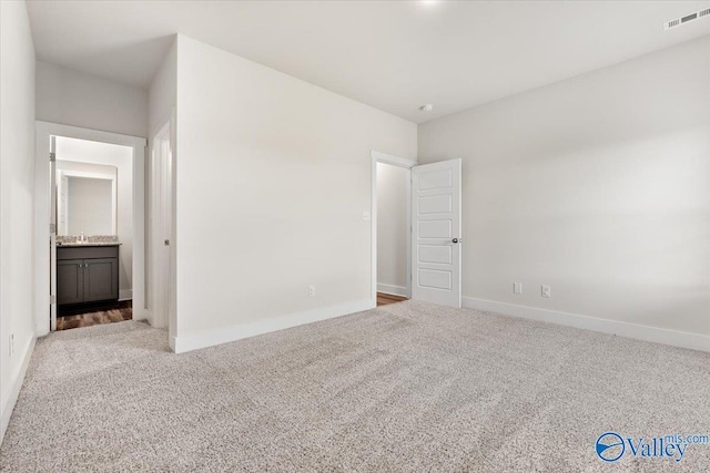 246 Tybee Dr, Madison, AL 35756 - unfurnished bedroom featuring carpet floors, baseboards, and ensuite bathroom