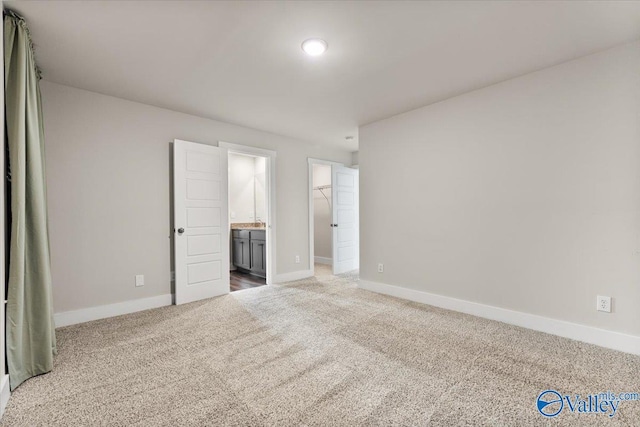 246 Tybee Dr, Madison, AL 35756 - unfurnished bedroom featuring carpet, baseboards, a spacious closet, and connected bathroom