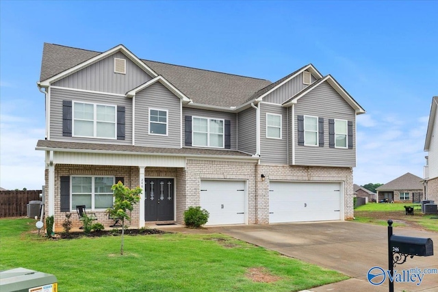 246 Tybee Dr, Madison, AL 35756 - view of front facade featuring brick siding, an attached garage, driveway, board and batten siding, and roof with shingles