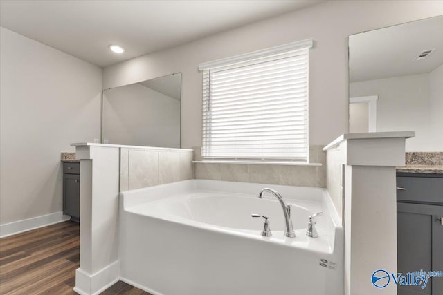 246 Tybee Dr, Madison, AL 35756 - full bath with vanity, a garden tub, wood finished floors, and baseboards