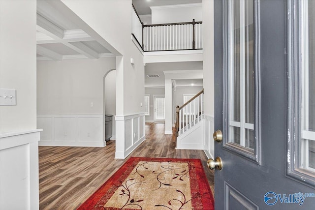 246 Tybee Dr, Madison, AL 35756 - foyer featuring crown molding, wood finished floors, stairs, arched walkways, and wainscoting