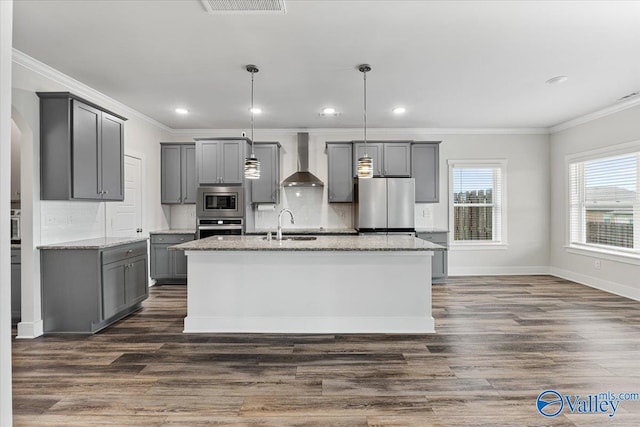 246 Tybee Dr, Madison, AL 35756 - kitchen with stainless steel appliances, gray cabinets, wall chimney range hood, crown molding, and tasteful backsplash