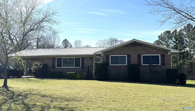 single story home featuring a front lawn and brick siding