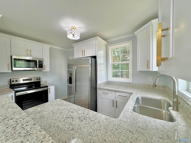 kitchen featuring light stone counters, white cabinets, sink, stainless steel appliances, and crown molding