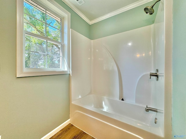 bathroom featuring shower / washtub combination, wood-type flooring, and a wealth of natural light