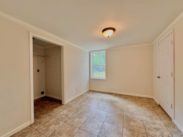 unfurnished bedroom with ornamental molding, a closet, a spacious closet, and light tile patterned floors