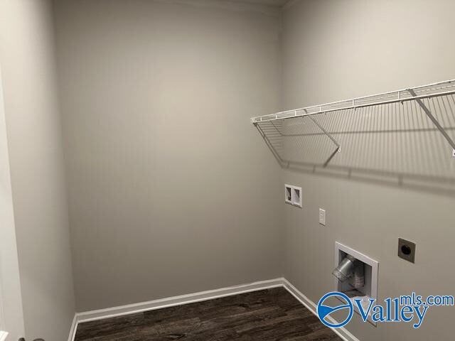 clothes washing area featuring hookup for an electric dryer, hardwood / wood-style floors, and washer hookup