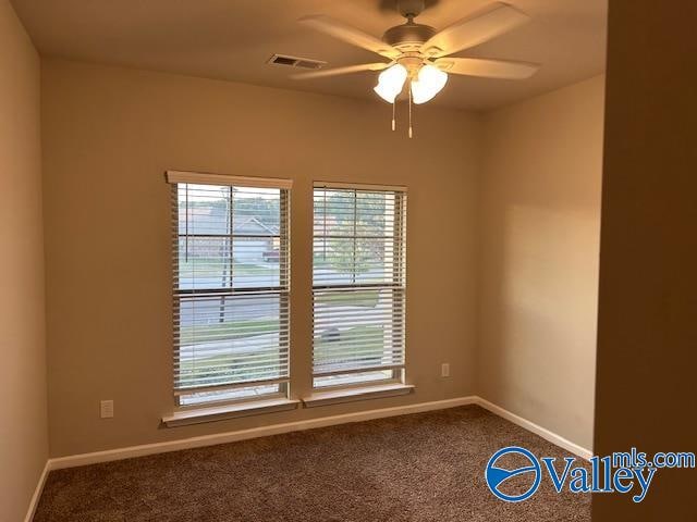 carpeted empty room featuring ceiling fan