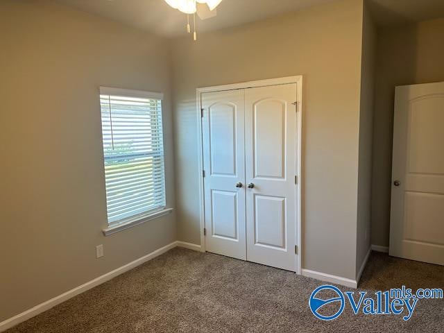 unfurnished bedroom with carpet and a closet