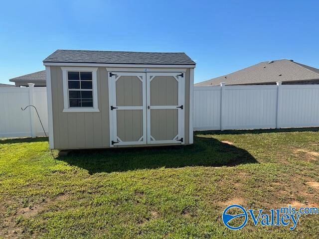 view of outbuilding featuring a yard